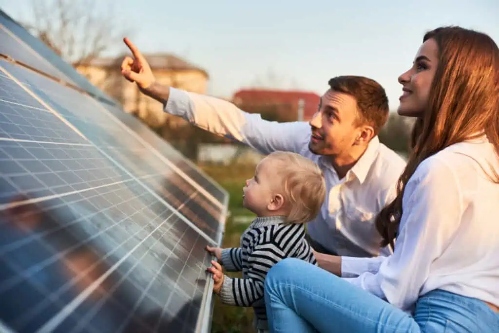 a man shows how many solar panels they need to the rest of the family